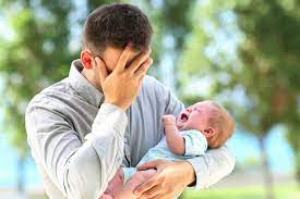 dad in distress with crying baby